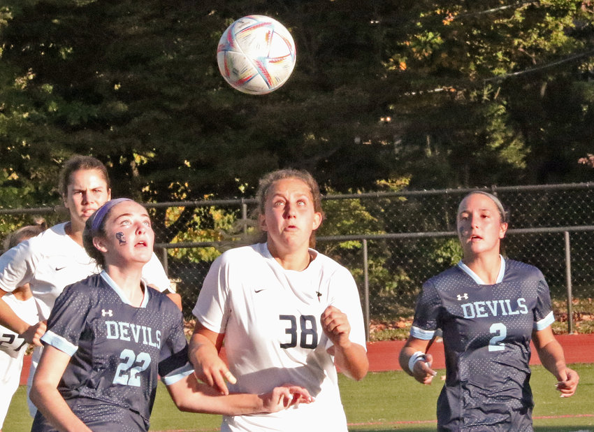 SCH senior Amanda McNesby (left) and GA junior Izzy Casey focus on the ball. At right is SCH senior Lisa McIntyre, back on the field for the first time following an injury.