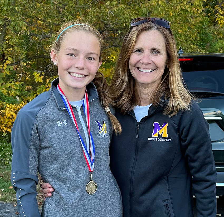 Two-time Catholic Academies champion Ella Woehlcke and Mount St. Joseph head coach Kitty McClernand.