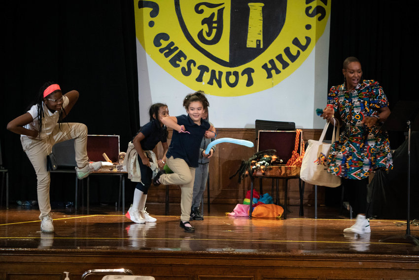Interactive storyteller, music and movement teacher Thembi Palmer dances with Jenks students, including Ava Sanders and Miya Soriano, at the Reading Promise event held at the Jenks Academy on Oct. 13.