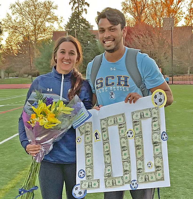 Nearing the end of her seventh season as SCH head coach, Maria Kosmin celebrates her 100th victory at the school last Thursday along with assistant coach Namit Deshpande.