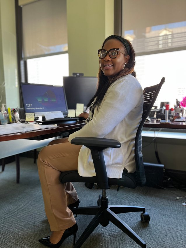 New Local board member Erica Paul at her desk at TruMark Financial Credit Union on the corner of Germantown and Highland Avenues, where she is an assistant vice-president branch manager.