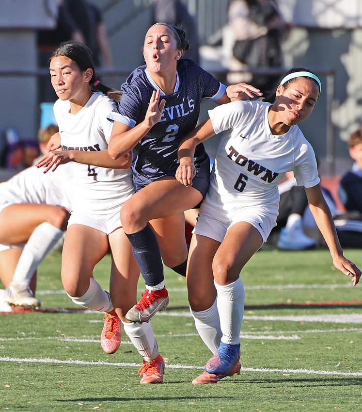 Going after the ball, SCH senior McIntyre (center) squeezes between Westtown's Sydney Costal (left) and Hayley Jurgens. McIntyre signed with the University of Maryland last Wednesday.