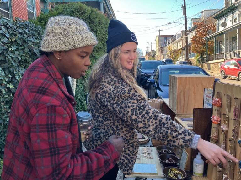 Yana Donaldson and Alyssa Weinfurtner look at jewelry at the Black Soul Block Party in Germantown on Saturday.