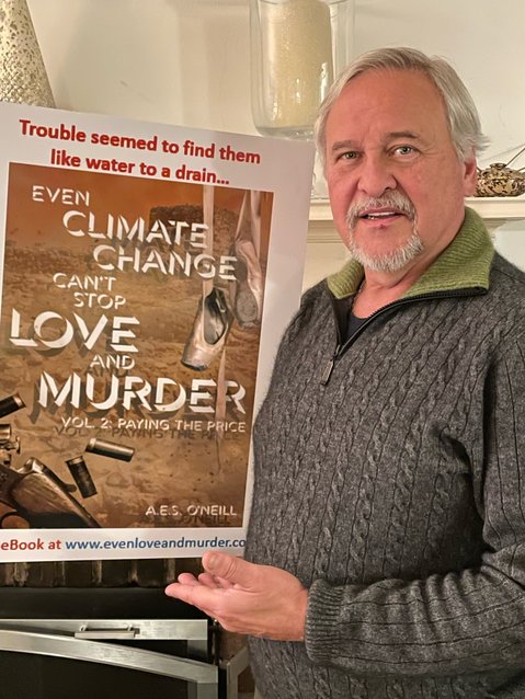 Alfred O&rsquo;Neill displays an advertising poster for his latest book, &ldquo;Even Climate Change Can&rsquo;t Stop Love and Murder.&rdquo;