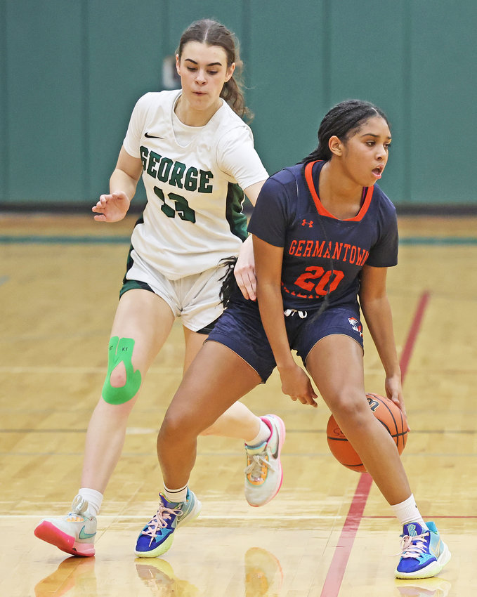Near midcourt, GFS sophomore Mia Rutledge displays some fancy ballhandling while guarded by George School's Basha Harrington, formerly of Germantown Academy.
