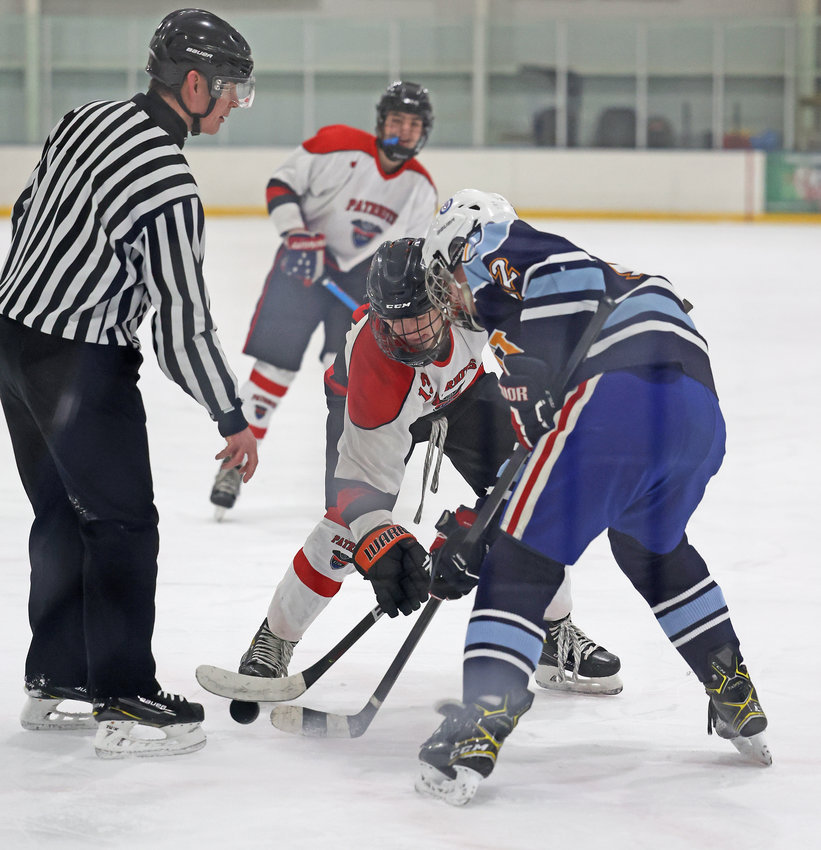 As the official drops the puck on a face-off, GA's Richie Podulka (center) and SCH's Sam Bevan go after it.