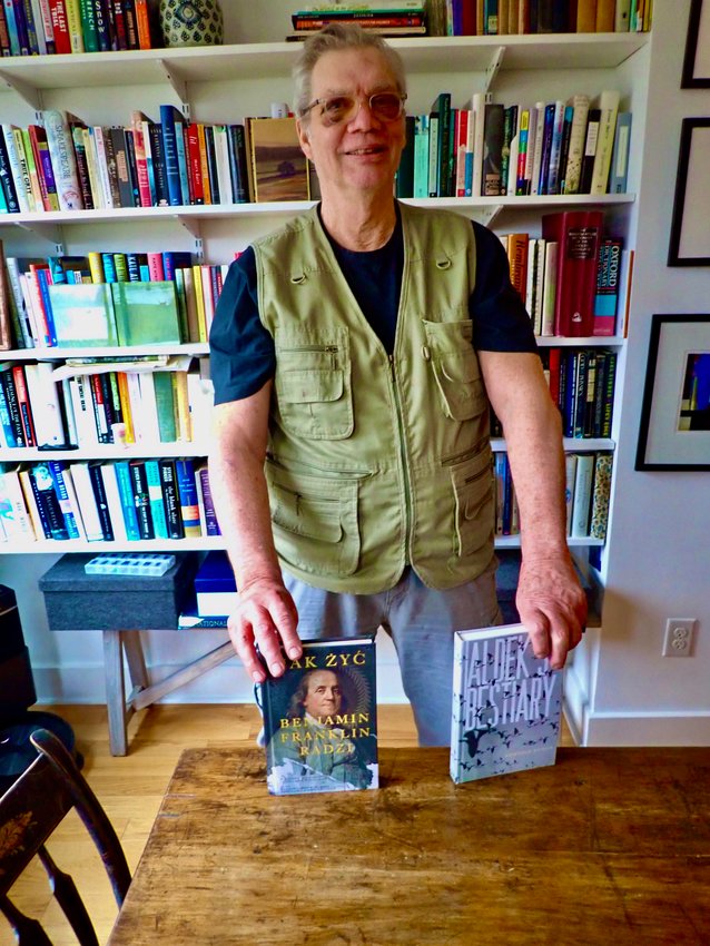 James Miller is seen in his Chestnut Hill home with two of the books his new company, Chestnut Hill Press, has published in recent months.