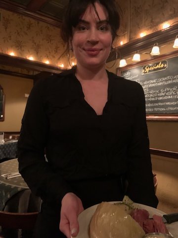 General Manager Madeline Hart serves a Shamrock Supper.