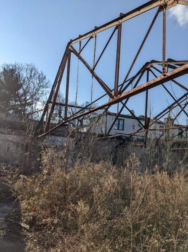 The old Mt. Pleasant Garage on Lincoln Drive had four stone walls and iron roof trusses before being demolished without a permit, prompting a stop-work order by city officials.