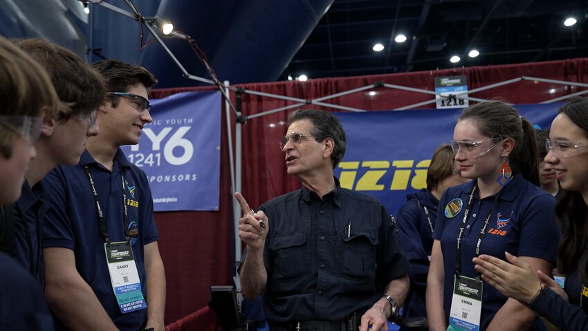 The 27 students on Springside Chestnut Hill Academy's robotics team traveled to FIRST Robotics World Championship in Houston, TX, this past week for the season's culminating event, one of only 10 percent of high school teams that qualified to compete at &quot;Champs.&quot; Students met event founder Dean Kamen, who stopped at the team's pit to talk to students and to hear about Team 1218's robot, affectionately called &quot;Stinger.&quot; Pictured left to right are Leo Cohen, Logan Landau, Danny O'Connor (a team captain), Dean Kamen (founder of FIRST Robotics), Emma Ludwikowski and Paige Murray.