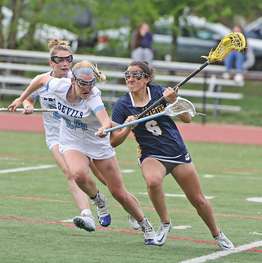 Penn Charter junior Aditi Foster (right), who scored a game-high four goals, is tightly marked by SCH senior Fallon George.