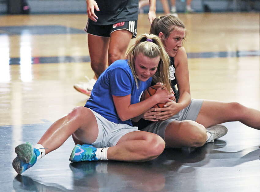 Cassie Murphy (right) of Team Black (Jefferson U.) wrestles for the ball with Royal Blue's Emma Pyne.