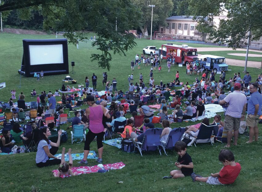 Movie&ndash;goers enjoy a night out at the movies on the grounds of the Water Tower Recreation Center in 2017.