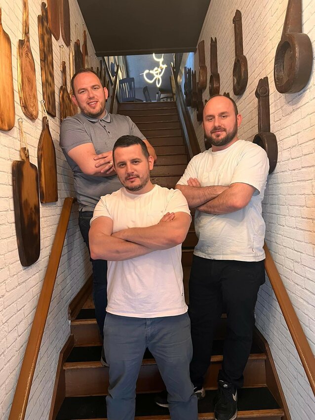 Brothers Jim (from left), Leo and Pep Osmanollaj, who built a restaurant business after fleeing Kosovo as war refugees, opened Toska in mid-June at 7136 Germantown Ave., former home of Earth Bread + Brewery restaurant, which closed last year.