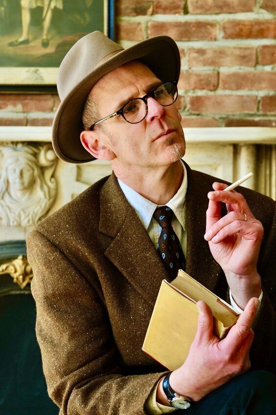 James Douglas Rosenthal, who just published a novel bashing the art world, does not smoke. He is holding a rolled up piece of paper in this photograph. Maybe he wants to look like Humphrey Bogart.