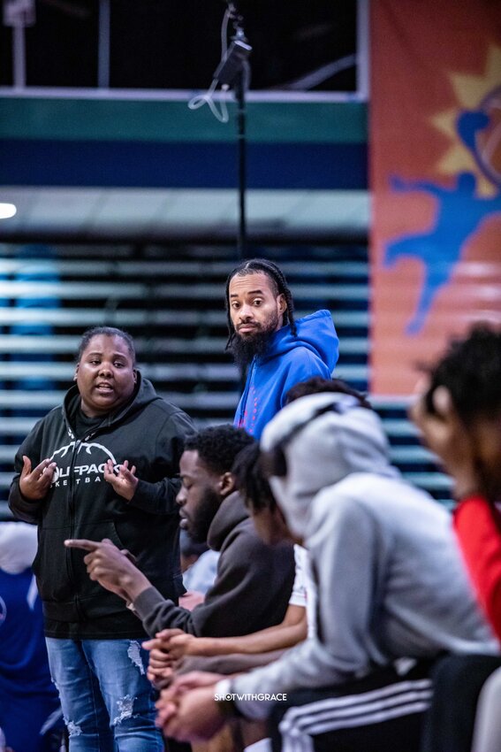 Co-founders of the Team First Elite AAU Basketball Program are Coach Cadiann Cole, at left in the black sweatshirt, and Coach Melvin Brown, standing and wearing a light blue hoodie.