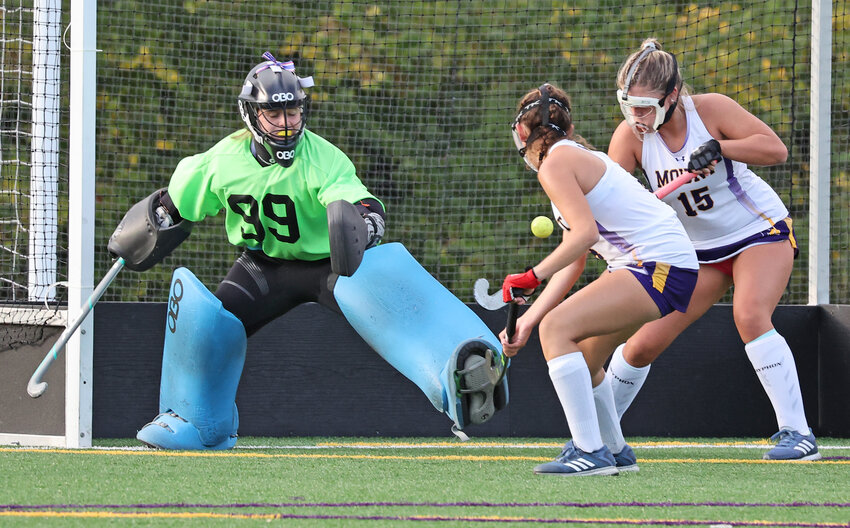 Mount goalie Lexi Kelly fights to keep the ball out of the cage, assisted by fellow sophomores Nora Massella (center) and Avery Lasky.