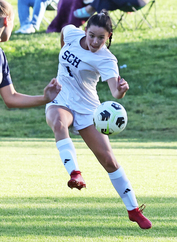 Senior Abby Udowenko launches an outside shot at the Baldwin goal.