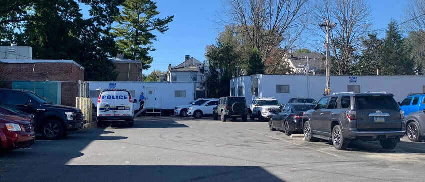 Several Hale Storage Trailers in the parking lot of the 14th district police headquarters are holding numerous police officers, staff and equipment.