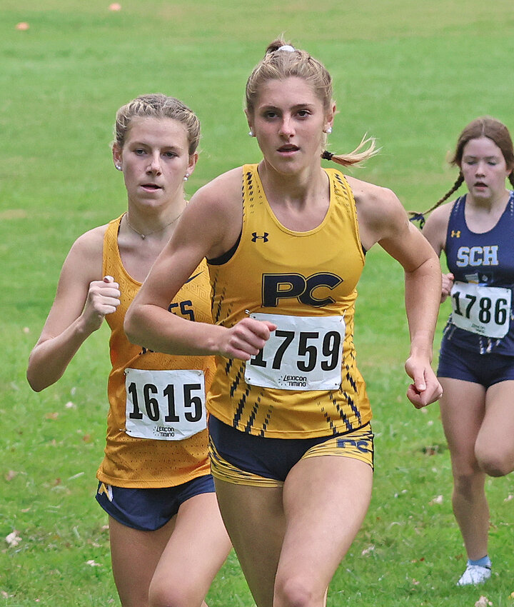 Just after the start of the Inter-Ac girls' race, PC junior Alli DeLisi is in the lead going up Flagpole Hill. Agnes Irwin's Avery Brennan is on her shoulder and SCH's Emma Hannigan is seen on the right, but DeLisi would soon separate from everyone else in the field.