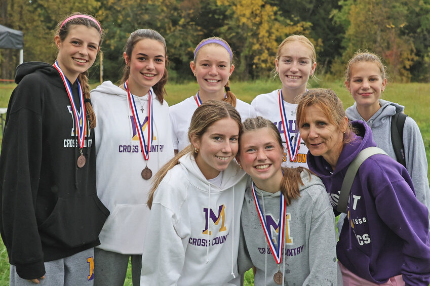 The Mount runners who participated in the varsity race celebrate their 2023 Catholic Academies championship. Rear, from left: Charli Schoen, Sarah Hock, Ella Woehlcke, Katie Westmoreland, Gianna Howe. Front, from left: Grace Daly, Annie Seminack, Coach Kitty McClernand.