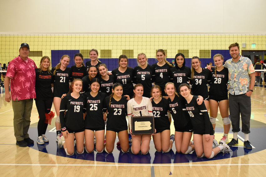 The Germantown Academy volleyball team gathers around the championship plaque after winning the Pa. Independent Schools tournament.