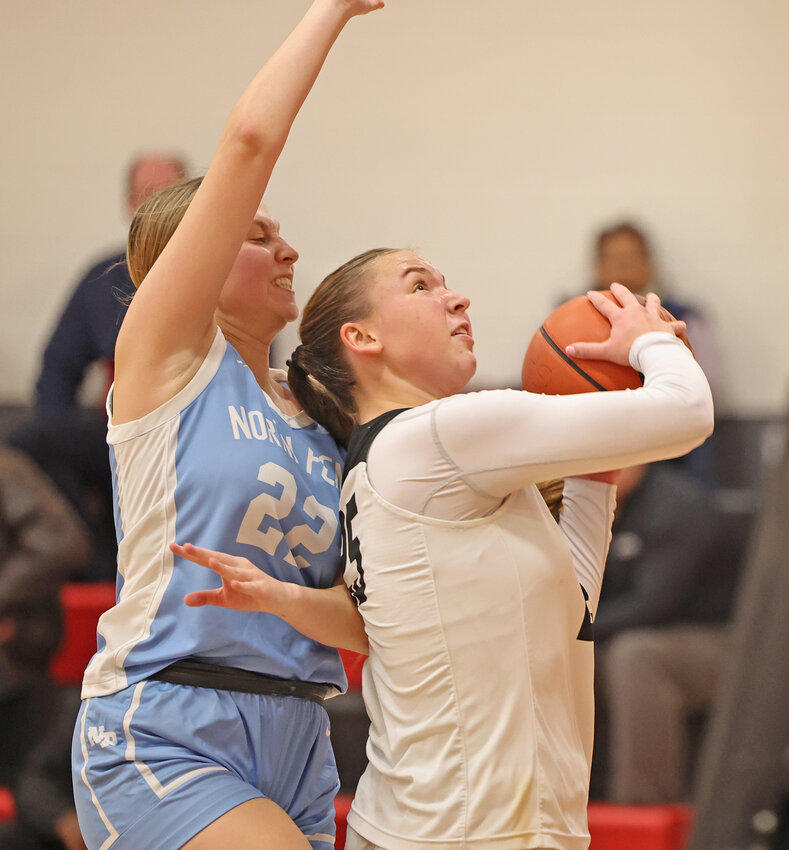 GA junior Gabby Bowes (right) tries to get off a shot while closely guarded by North Penn's Leah Mikulski.