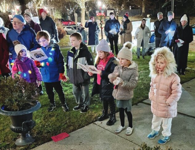 Friends and neighbors arrived at Christ Ascension Lutheran Church on Monday night for Caroling at the Creche, a beloved holiday custom that dates back four decades. The event, designed to counteract the commercialization of Christmas, has been set up at various locations on the Hill, including the former Santander Bank location, the Chestnut Hill Library and the Chestnut Hill East train station. Volunteers bring their musical instruments as well as their holiday spirit. The event, which features a creche adorned with a star, lights, fresh greenery and straw, is sponsored by The Friends of the Creche and the Chestnut Hill Library as well as several small businesses that donate food and drink. Church preschoolers baked cookies, Robertson's Flowers provided 25 feet of greens rope and Ginny Williams once again donated greens for the manger.