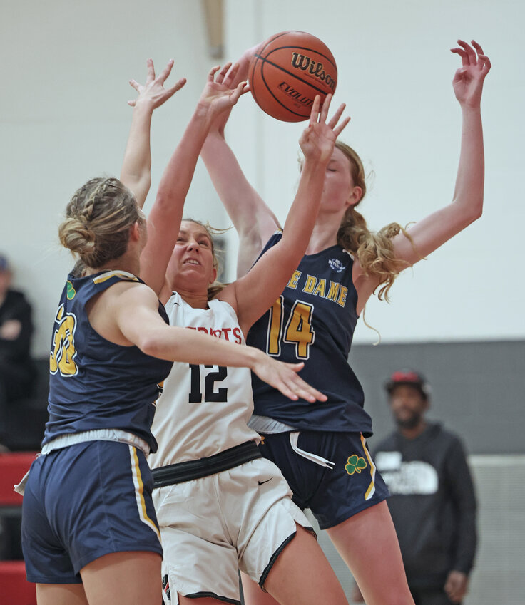 GA's high scorer, senior Izzy Casey (center) tries to get off a shot against Notre Dame's Sophie Hall (left) and Grace Nasr. (Photo by Tom Utescher)