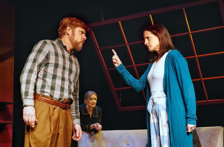 Eric Crist (left) and Claire Golden Drake (right) exchange heated words as Laura Christman watches in a scene from Yasmina Reza&rsquo;s &ldquo;God of Carnage,&rdquo; on stage through Feb. 25 at The Stagecrafters Theater in Chestnut Hill.