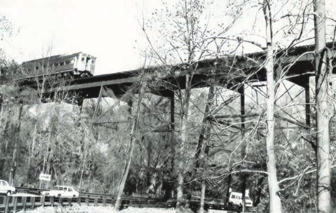 An early 1980s view of the original 1884 trestle spanning the Cresheim Valley. SEPTA cited the poor condition of the trestle as a reason to eliminate the Chestnut Hill West line in the 1980s until funding came through, and the trestle was replaced in 1989 with the steel and concrete bridge that exists today.