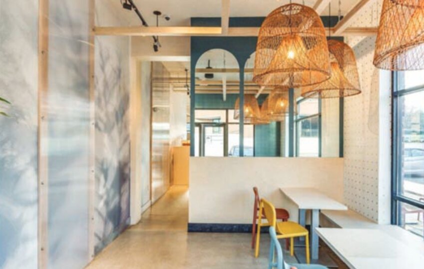 The wallpaper in this restaurant space was custom-made using the shadows that some houseplants cast on a large white wall.