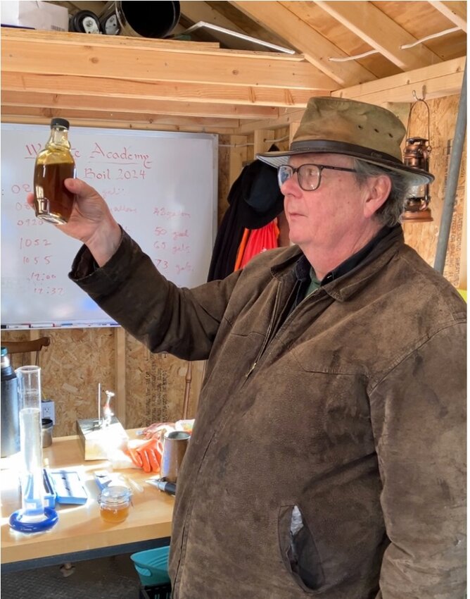 Wayne Skilton, a volunteer and retired chemical technician who operates the maple evaporator for the Wyncote Academy program, proudly shows the finished syrup. It takes 40 gallons of sap to produce one gallon of maple syrup.