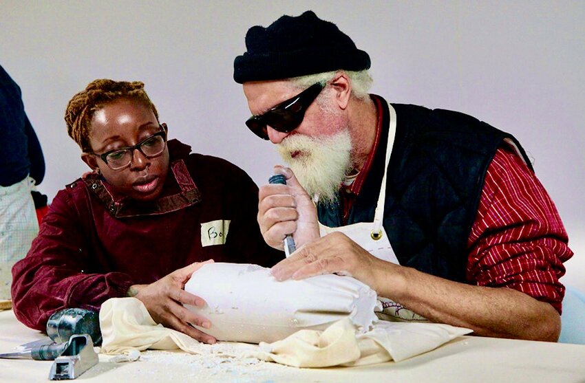 Ron Bryant is seen working with a volunteer instructor (name unknown) at Allens Lane Art Center's groundbreaking Vision Thru Art program for vision-impaired and blind artists. Bryant's work is now on exhibit through March 29 at Allens Lane Art Center.