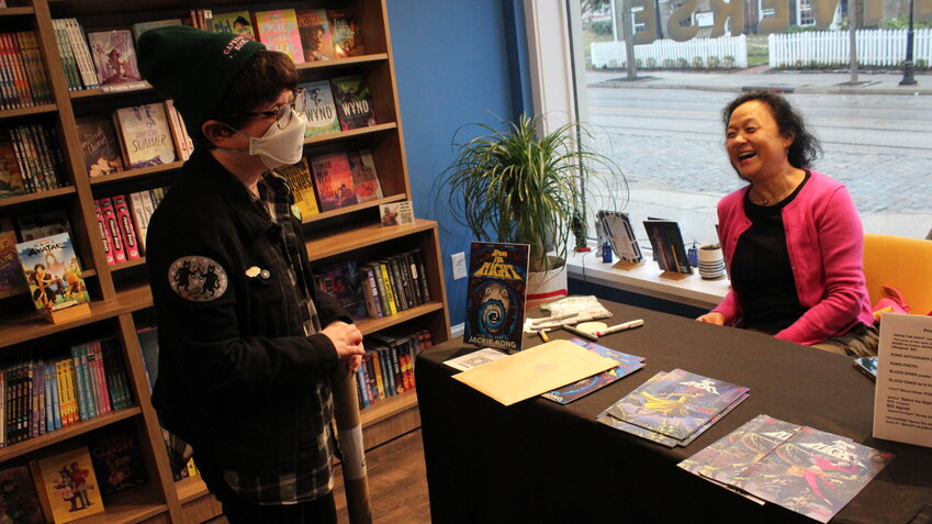 Movie director Jackie Kong (right) chats with a fan.