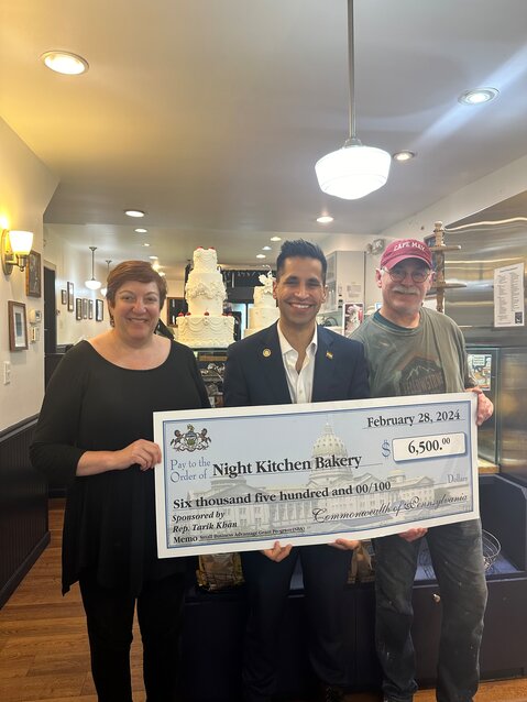 State Rep. Tarik Kahn (center) recently presented a $6,500 check to the Night Kitchen Bakery at 7725 Germantown Ave. through the Small Business Advantage Grant Program. The funds will help the legendary community business replace a walk-in refrigerator.