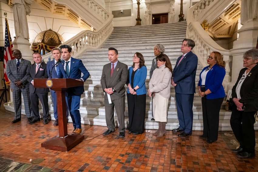 Rep. Tarik Khan (at podium) with a bipartisan group of 10 state legislators in the Capitol rotunda in Harrisburg.