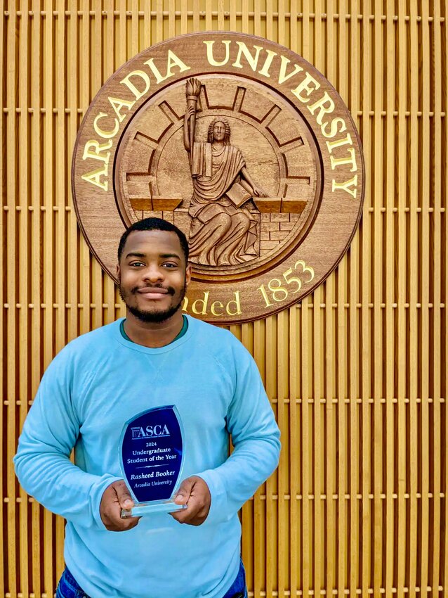 Rasheed Booker, a Mt. Airy resident and senior at Arcadia University, proudly holds up his &ldquo;Undergraduate Student of the Year Award.&rdquo; He won over 70 other nominees from all over the country.