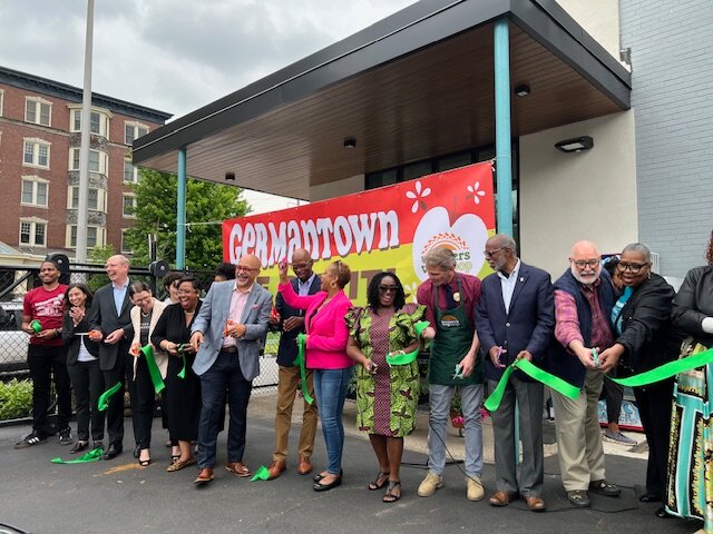 State, federal, and city officials who stood to cut the actual ribbon joked about who had raised the biggest sum. Most of the credit went to U.S. Rep. Dwight Evans for helping create Pennsylvania's Fresh Food Financing Initiative in 2004. Photo by Ann Marie Doley