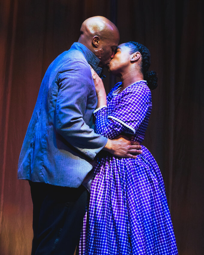 Kelechi Udenkwo (left) and Deja Anderson-Ross share a loving moment in the Quintessence Theatre Group&rsquo;s production of &ldquo;Father Comes Home from the Wars  (Parts 1, 2, and 3,)&rdquo; running through June 23.