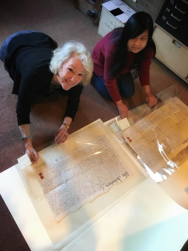 Liz Jarvis and intern Nicole Hudson from Jefferson University comb through a series of deeds, indentures and plans that the conservancy received from Joe Van Sciver in 2017.