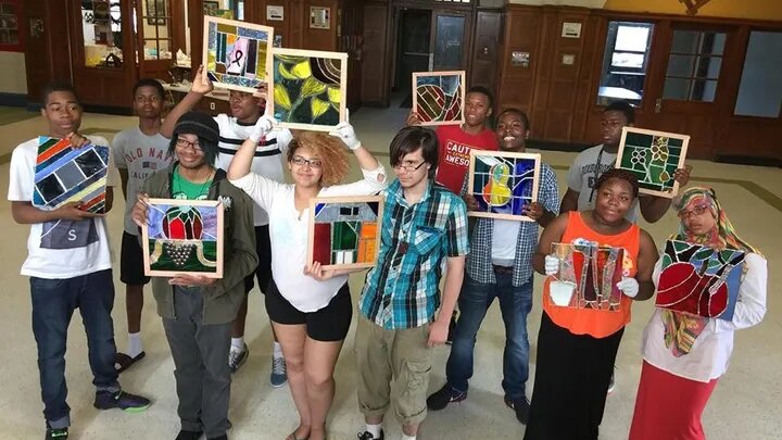 Students of The Stained Glass Project show off their work.