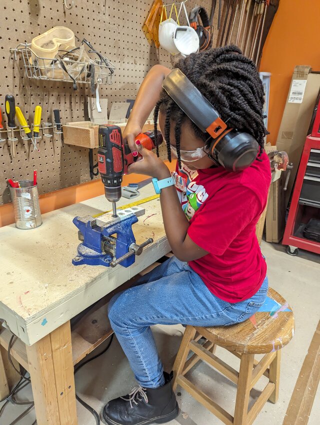 A student participates in woodshop lessons that are part of Natural Creativity, a nonprofit learning community.