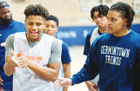 Jordan Dill&rsquo;s (left) leadership abilities have matured with age. Here he discusses tactics with Coach Jamil Pines-Elliot (right) and the rest of the varsity team.