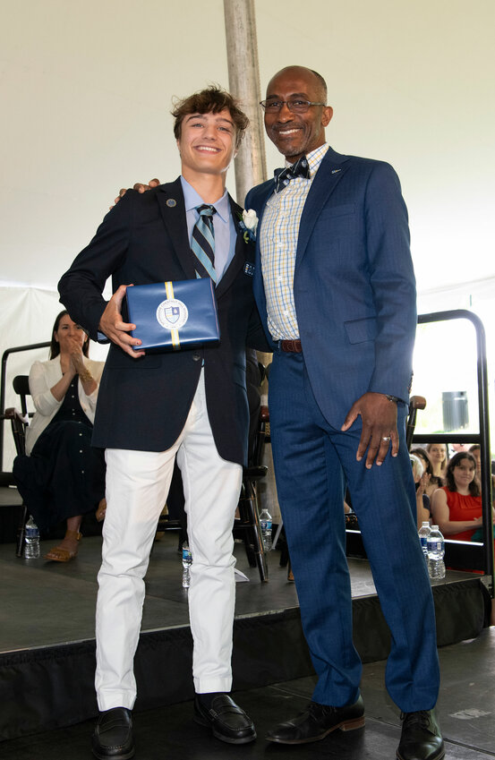 Head of School Delvin Dinkins presents Ryan Agnew with the Shield Award.