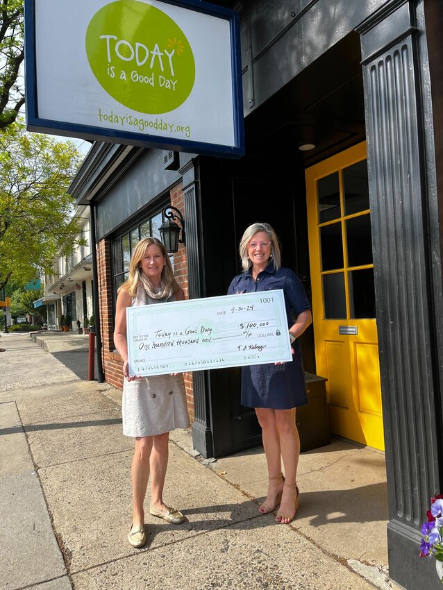 Martha Sharkey (right), founder of local nonprofit, Today is a Good Day, which provides personal and financial support for families with babies in Neonatal Intensive Care Units, receives a $100,000 donation from the Kelsey-Naylor Family Foundation. It was secured for TIAGD by Wyndmoor residents Mandy (left) and Chuck Marion.