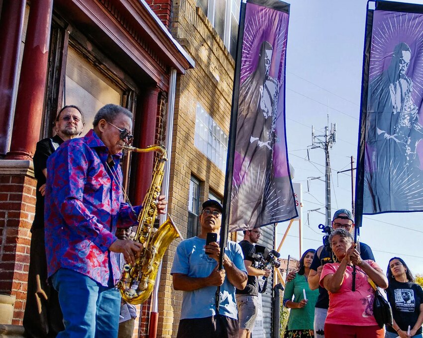 Odean Pope, playing in front of the John Coltrane House at 1511 North 33rd St., a National Historic Landmark, in 2018. Saxophonist and jazz pioneer John Coltrane was Pope's friend and gave him his first musical job in 1955.