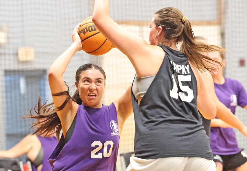 Team Purple's Anna McTamney (with ball) is guarded by Cassie Murphy of Jefferson's Team Black.