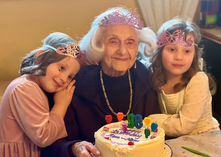 Betty Matusow Perlmutter, who was 100 on April 4, with her great-granddaughters, Maia and Juliana Zilber-Reusing, who are rising second graders at Henry School in Mt. Airy.