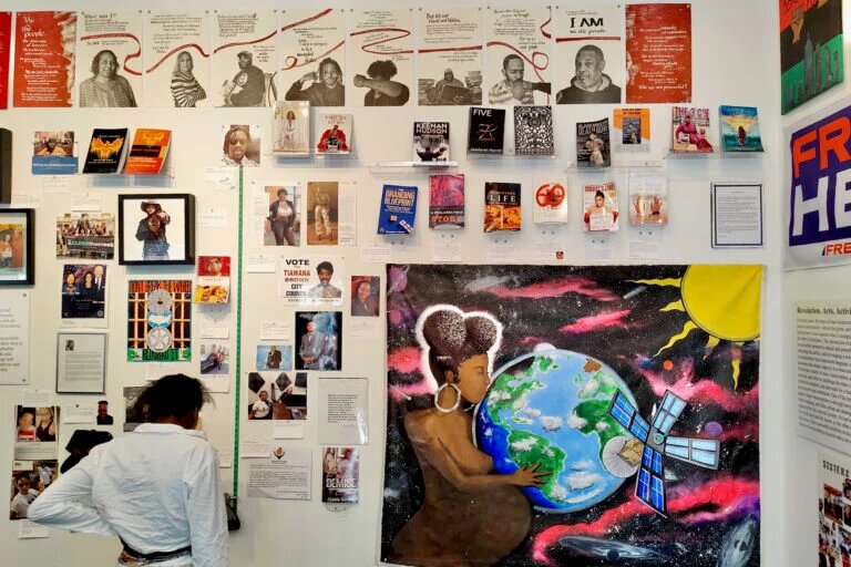 A visitor looks at the &ldquo;Inspiration&rdquo; wall of writings, testimonials and artwork by people who were formerly incarcerated.